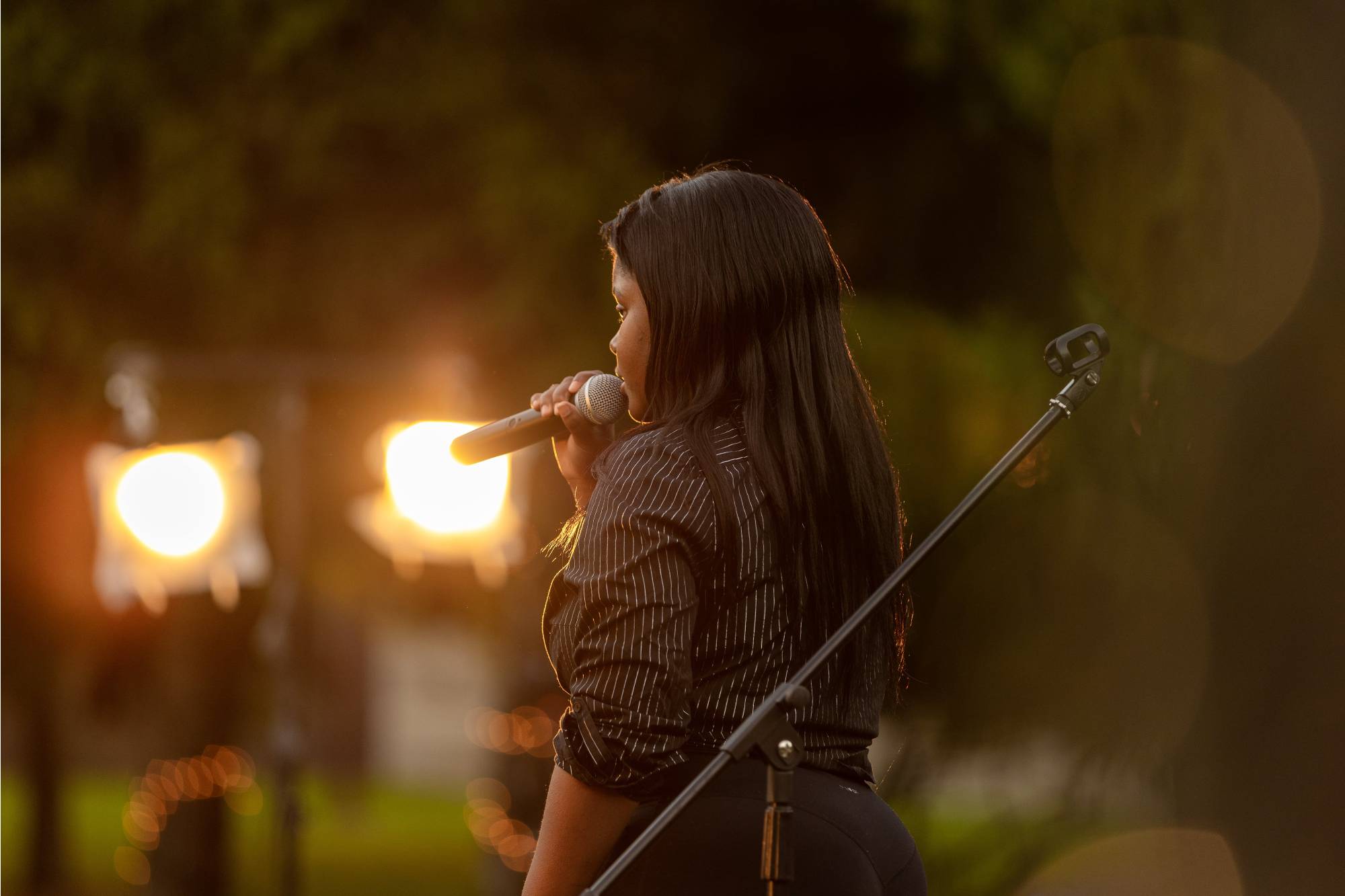 Opening act Armani Thompson singing on stage